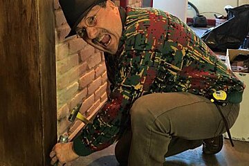 a man doing some building work in a bar