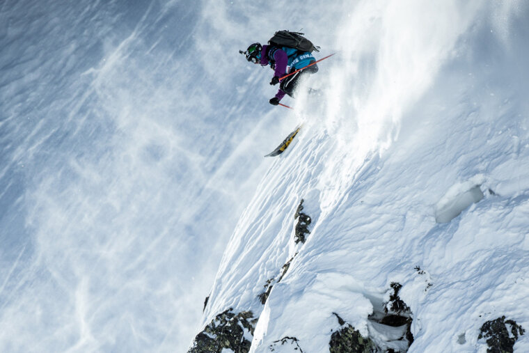 a ski jumping a steep cliff in a competition
