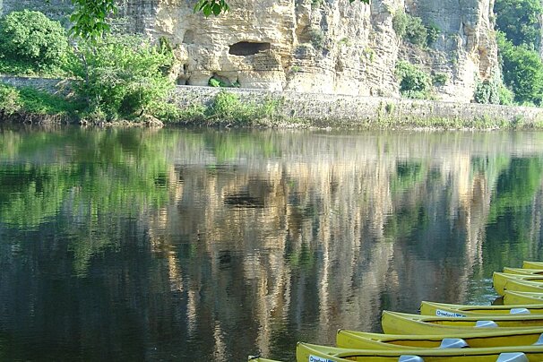 yellow canoes lined up on the river bank