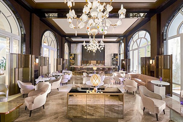 A large room with tables and chairs and a chandelier