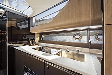 A kitchen on a boat with a sink and stove
