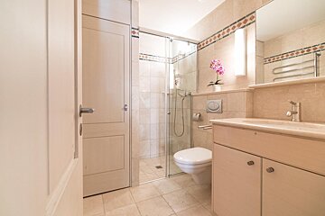 A bathroom with a toilet a sink and a shower