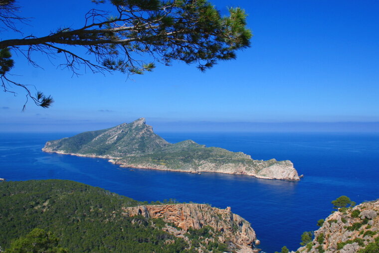 A small island in the middle of a large body of water