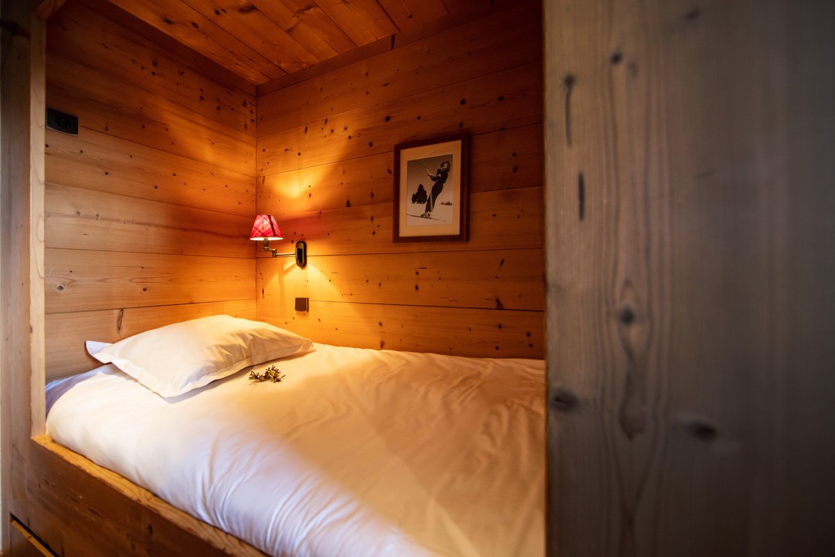 A bed with a picture on the wall above it