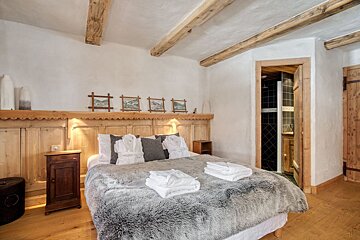 A bedroom with a king size bed and a nightstand