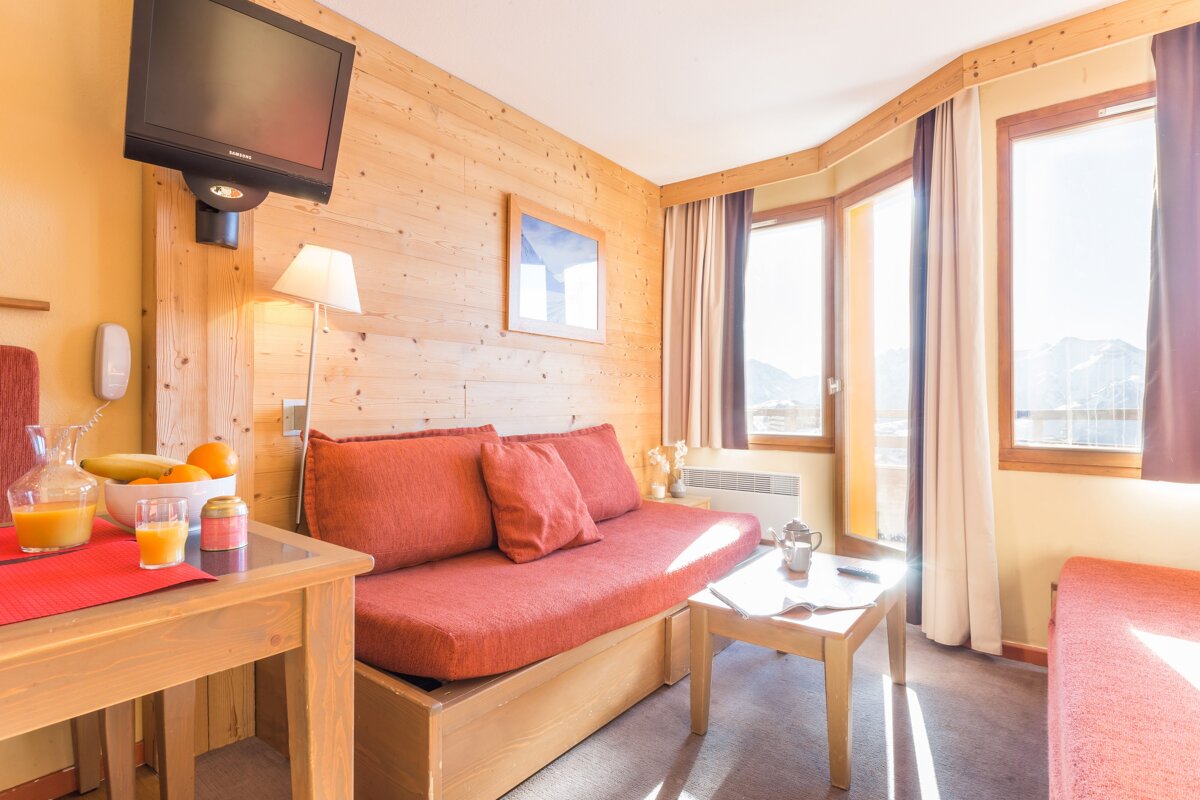 A living room with a couch and a flat screen tv