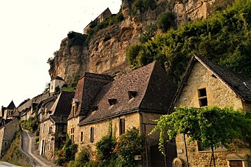 a road leading up through cottages in beynac