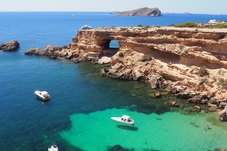 Green and dark blue waters along the coast of ibiza