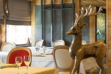 A statue of a deer sits on a table in a restaurant
