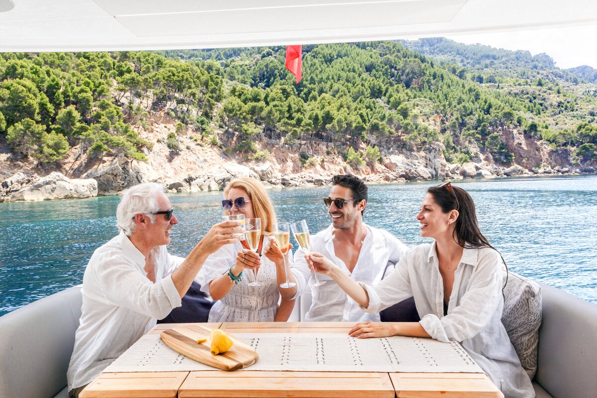 A group of people toasting with champagne on a boat