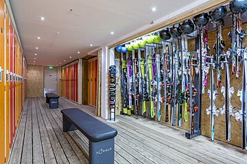 A locker room with a bench that says coral on it