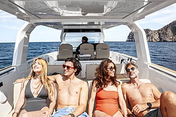 A group of people are sitting on a boat that says perfect