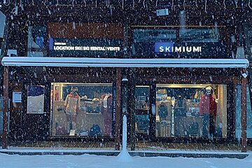 A ski shop called skimium is covered in snow