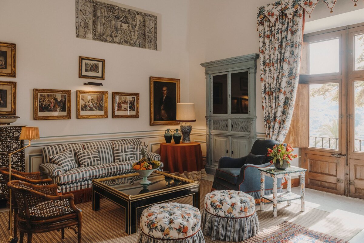 A living room with a striped couch and chairs
