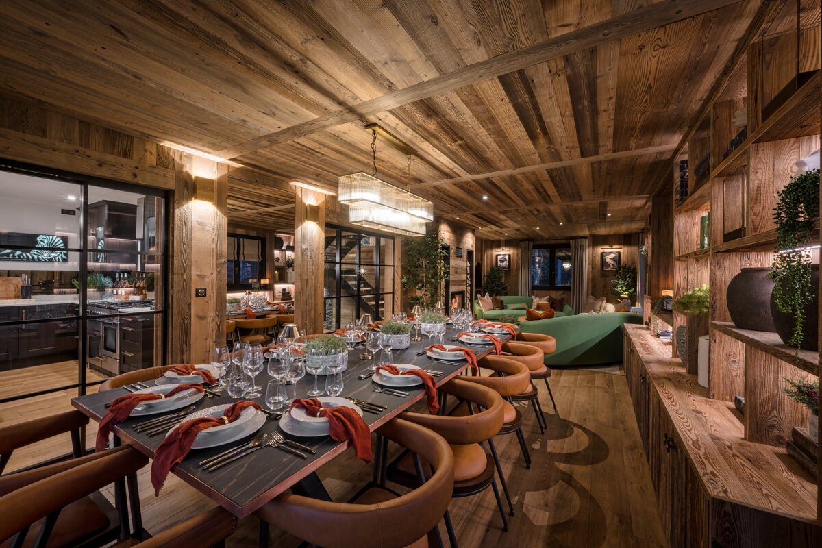 A dining room table with plates and utensils on it