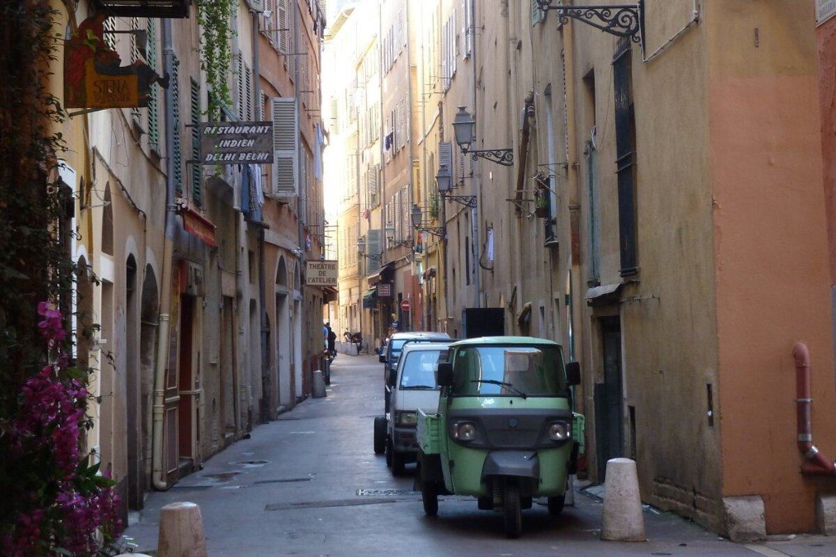 Old narrow street and small van in Nice