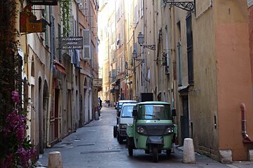 Old narrow street and small van in Nice