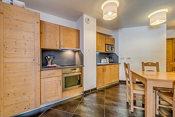 A kitchen with wooden cabinets and stainless steel appliances