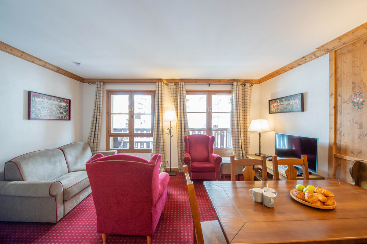 A living room with a couch a chair and a table