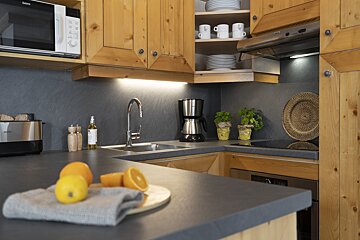 A kitchen with wooden cabinets and a microwave that says ' siemens ' on it