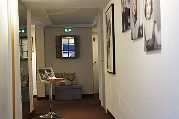 A hallway with a few pictures on the wall