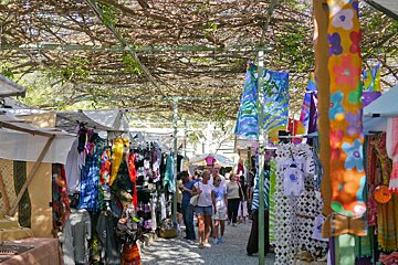 A group of people are shopping at a colorful market