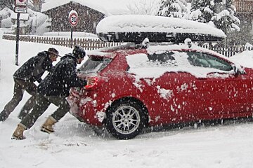 pushing car in snow