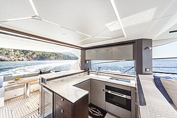 A kitchen on a boat with a rug that says ' alpenschenker ' on it