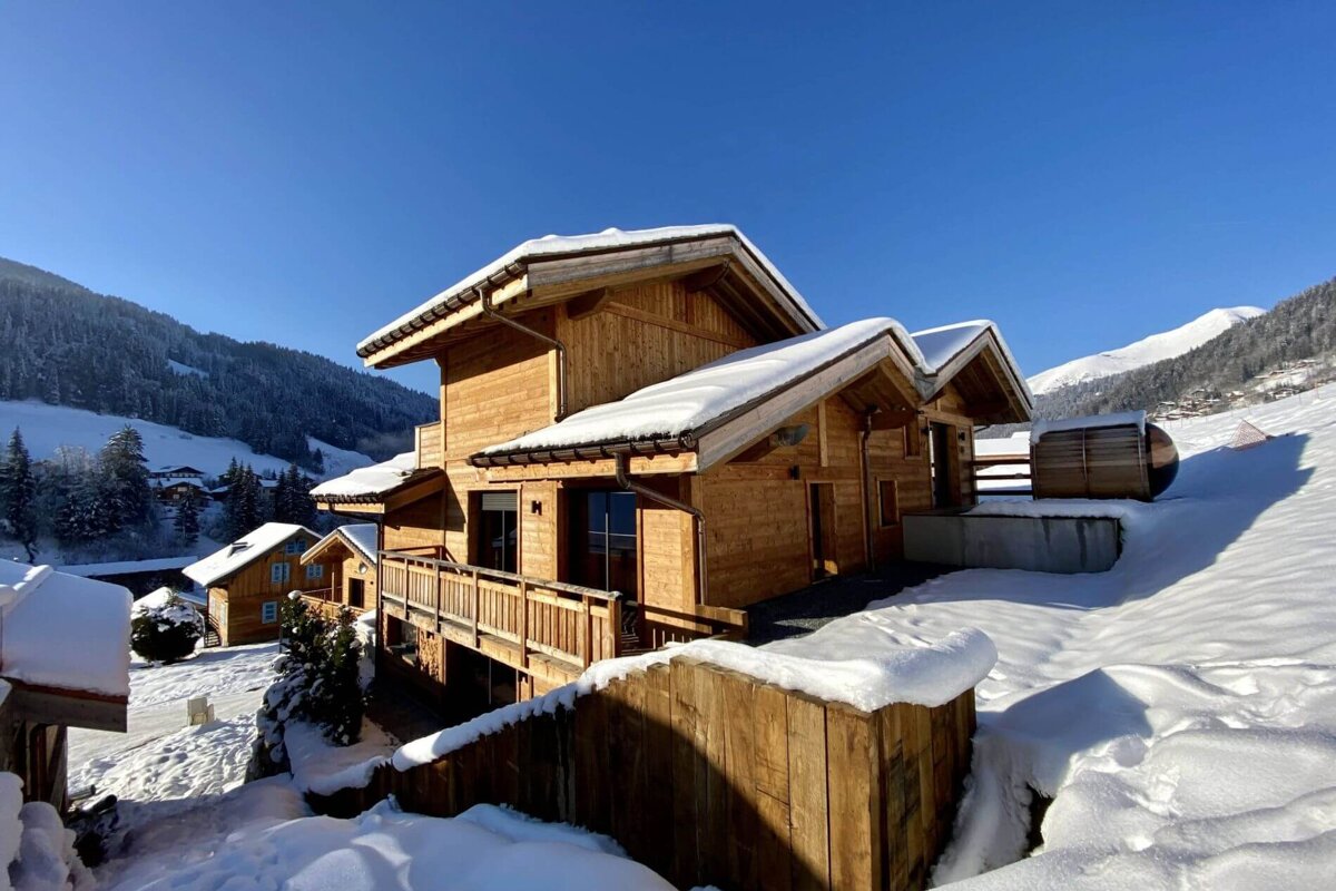 A snowy house with a blue sky in the background