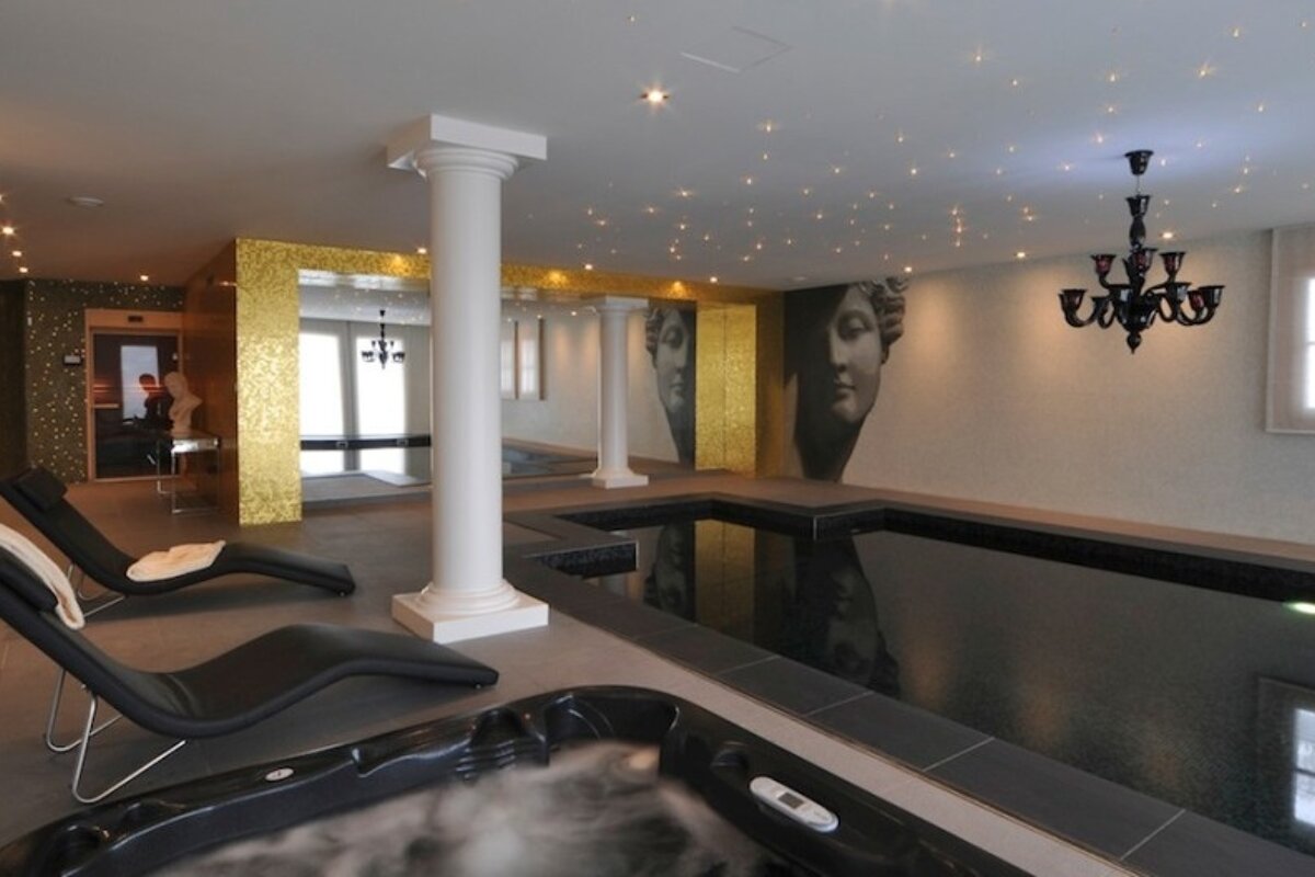 A swimming pool with a chandelier hanging from the ceiling