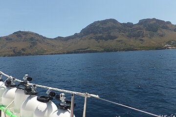 A large body of water with mountains in the background