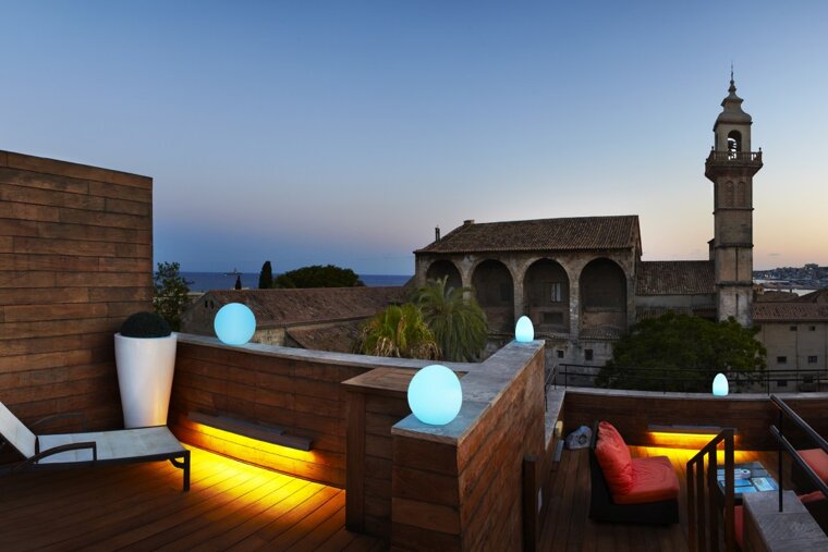 A view of a city from a balcony with a clock tower in the background