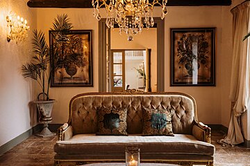 A living room with a couch and a chandelier