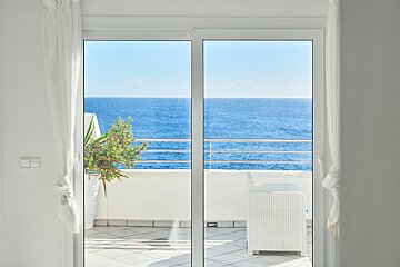 A view of the ocean through a sliding glass door