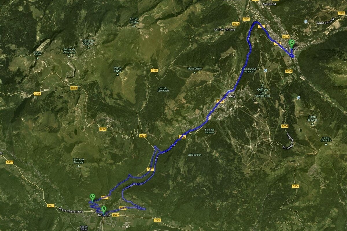 An aerial view of a mountain range with a blue line showing the route