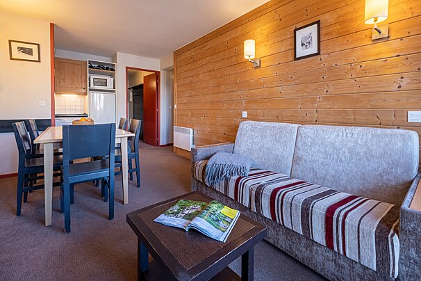 A living room with a couch a table and chairs