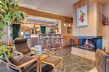 A living room with a fireplace and a bar