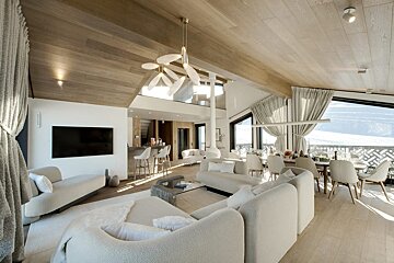 A living room with white furniture and a flat screen tv