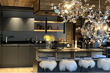 A kitchen with a vase of flowers on the counter