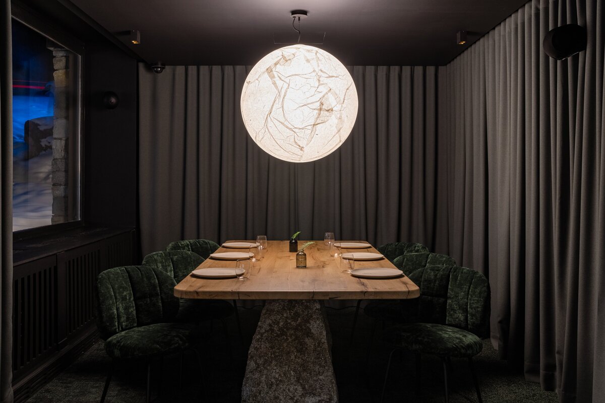A table with plates and glasses on it in a dark room