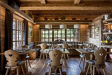 A dining room with tables and chairs and a sign on the ceiling that says 2010