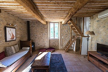 A living room with a staircase leading up to the second floor