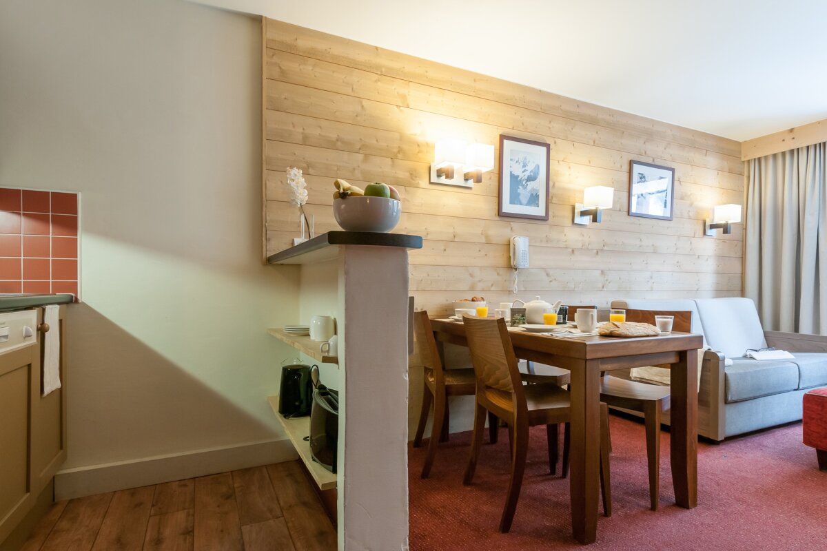 A living room with a table and chairs and a couch
