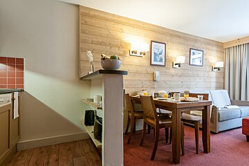 A living room with a table and chairs and a couch