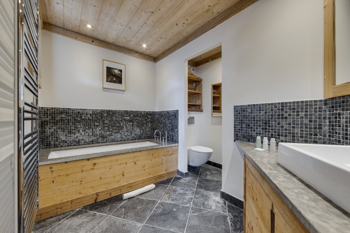 A bathroom with a bathtub a toilet and a sink