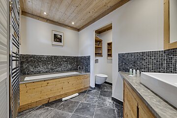 A bathroom with a bathtub a toilet and a sink