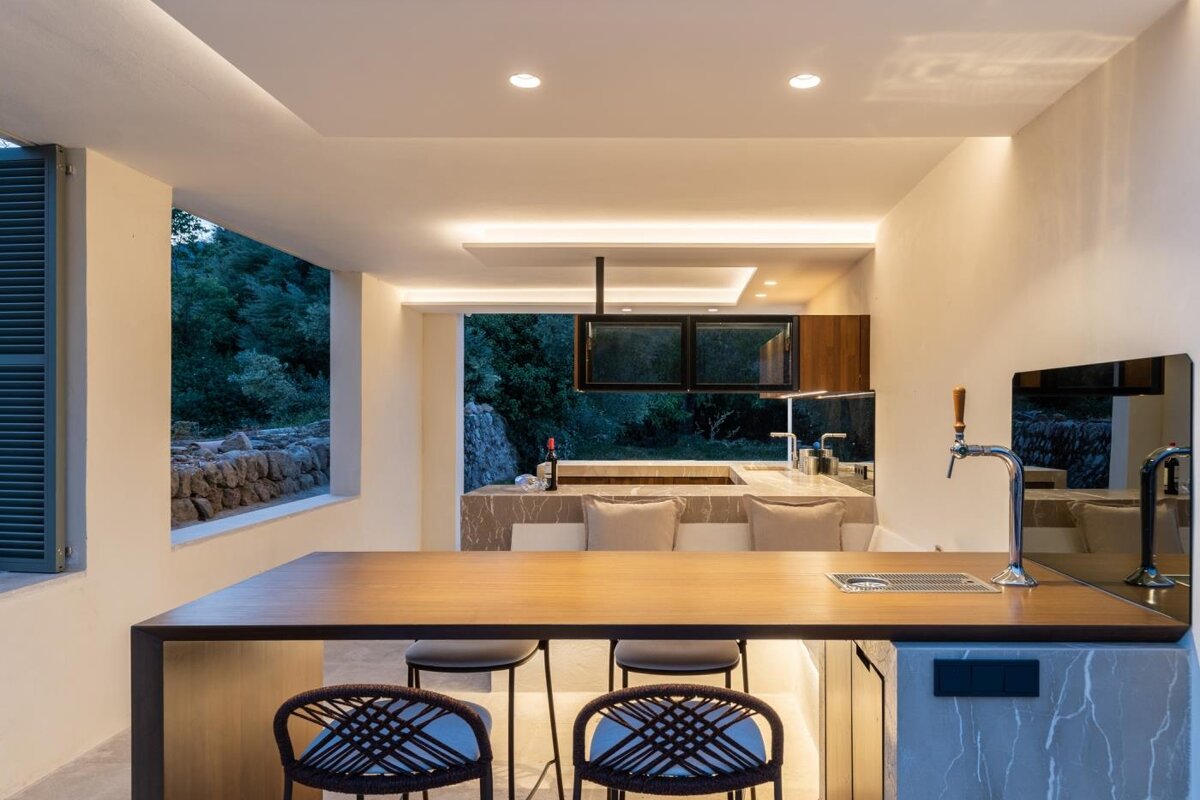 A kitchen with a large wooden table and chairs