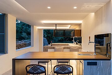 A kitchen with a large wooden table and chairs