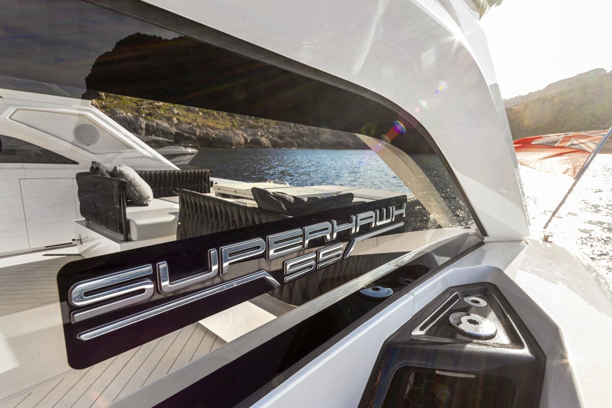 The word superhawk is on the side of a boat