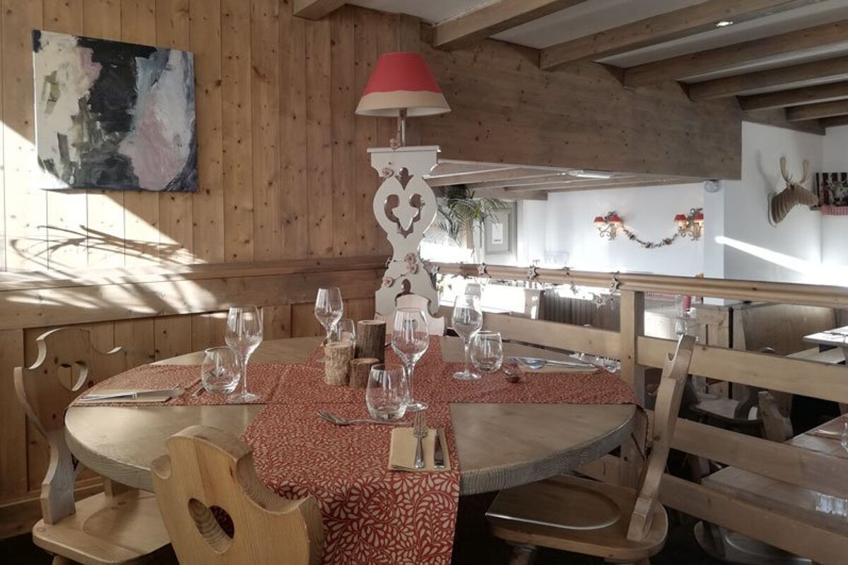 A table with a red table runner and glasses on it